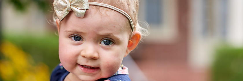 Hemophilia patient smiling for photos with her family in French Park.