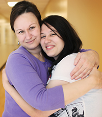 Parent and child hug each other.
