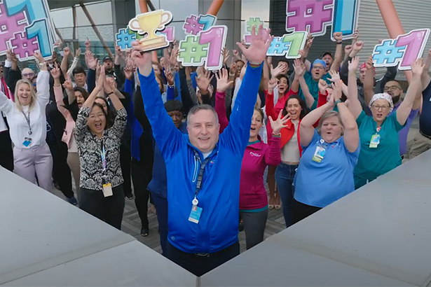 Employees holding #1 signs.