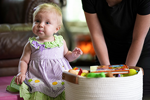 A little girl sits and plays.