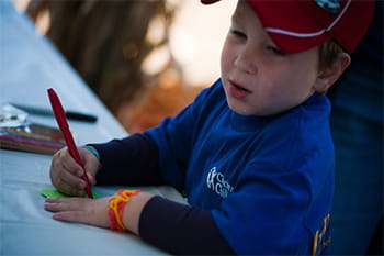 Little boy writing on a paper.